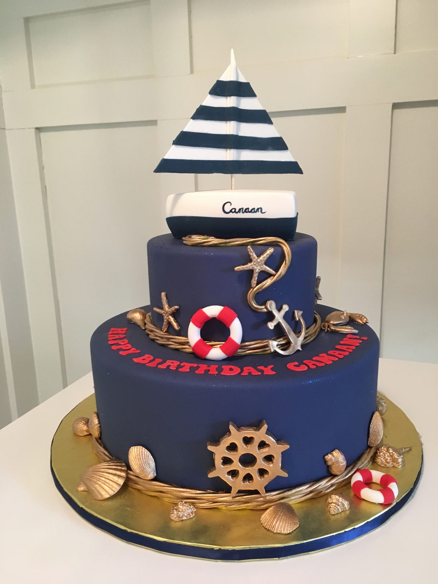 Navy nautical birthday cake with a sailboat